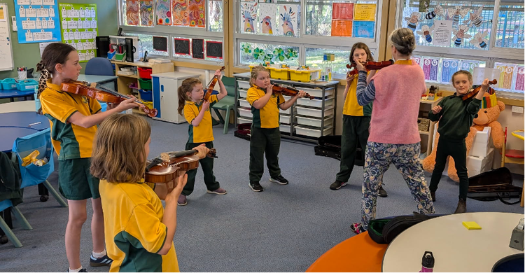 students with parent teaching violin