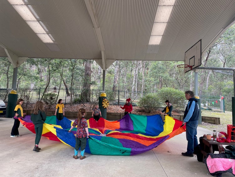 students under a COLA with bright colourful parachute