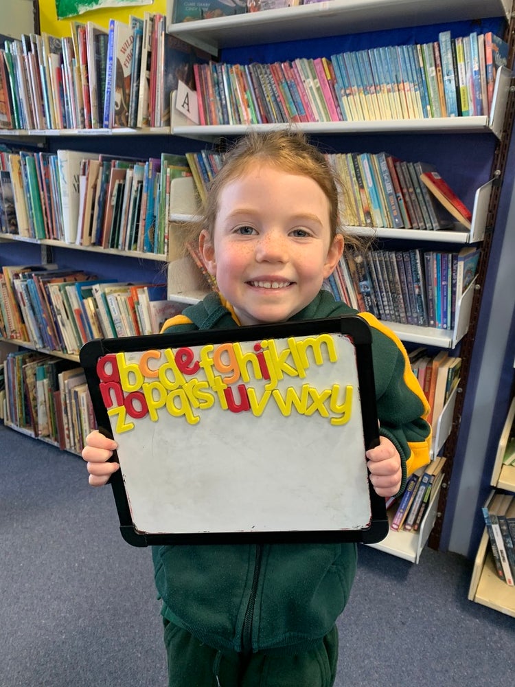 students learning the alphabet with magnetic letters