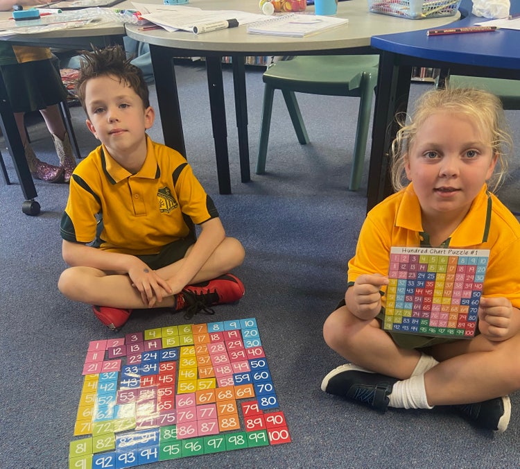 2 students on carpet playing a game